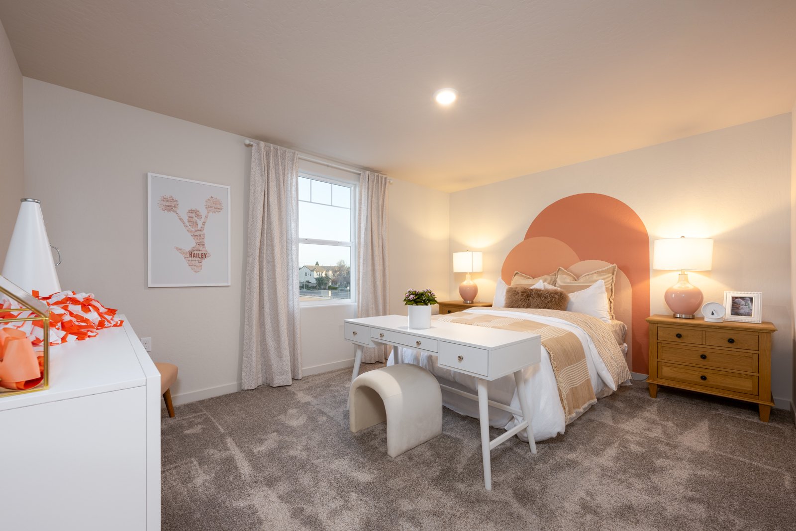 A bedroom with a bed and a desk.