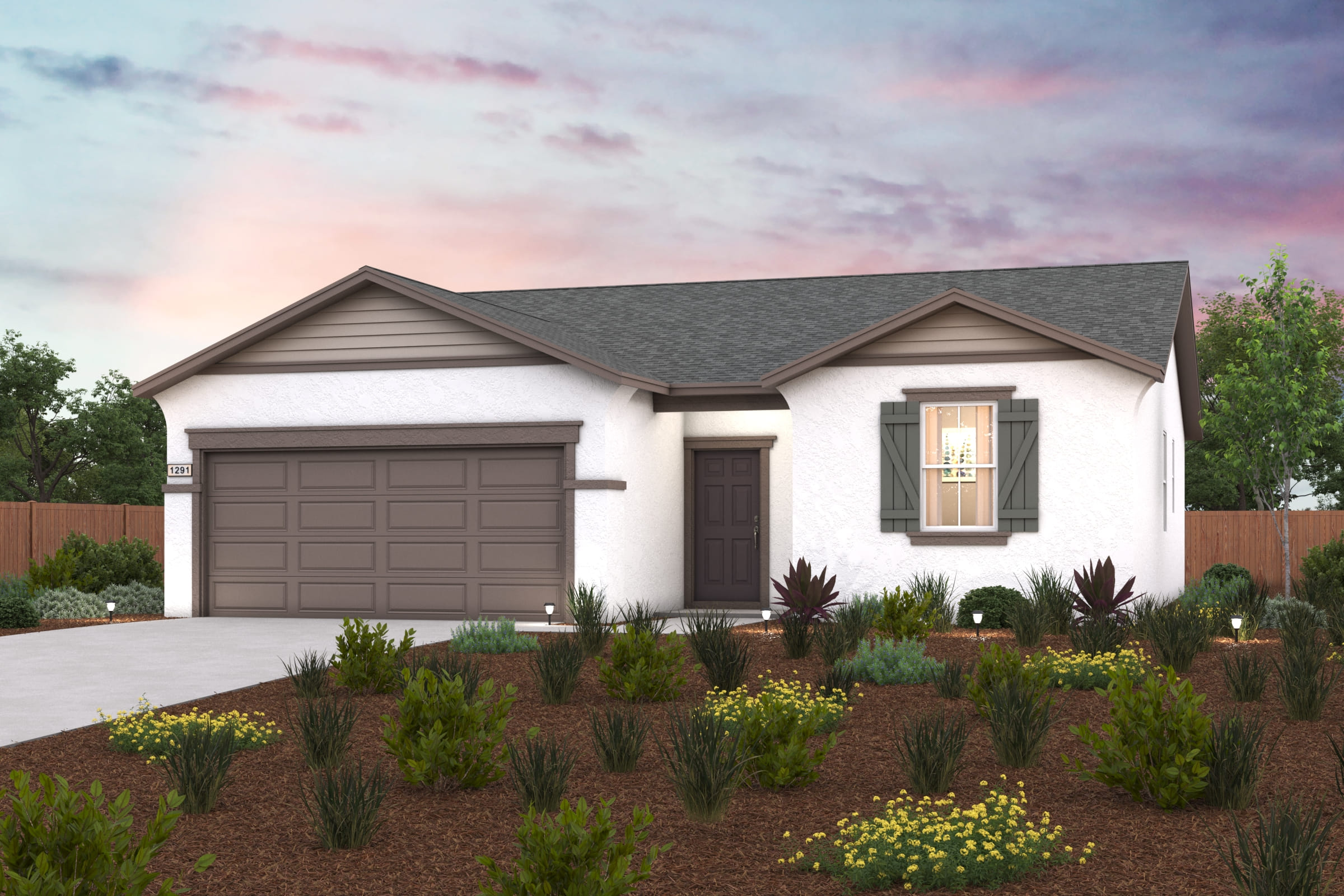 A house with a garage and bushes in front of it.