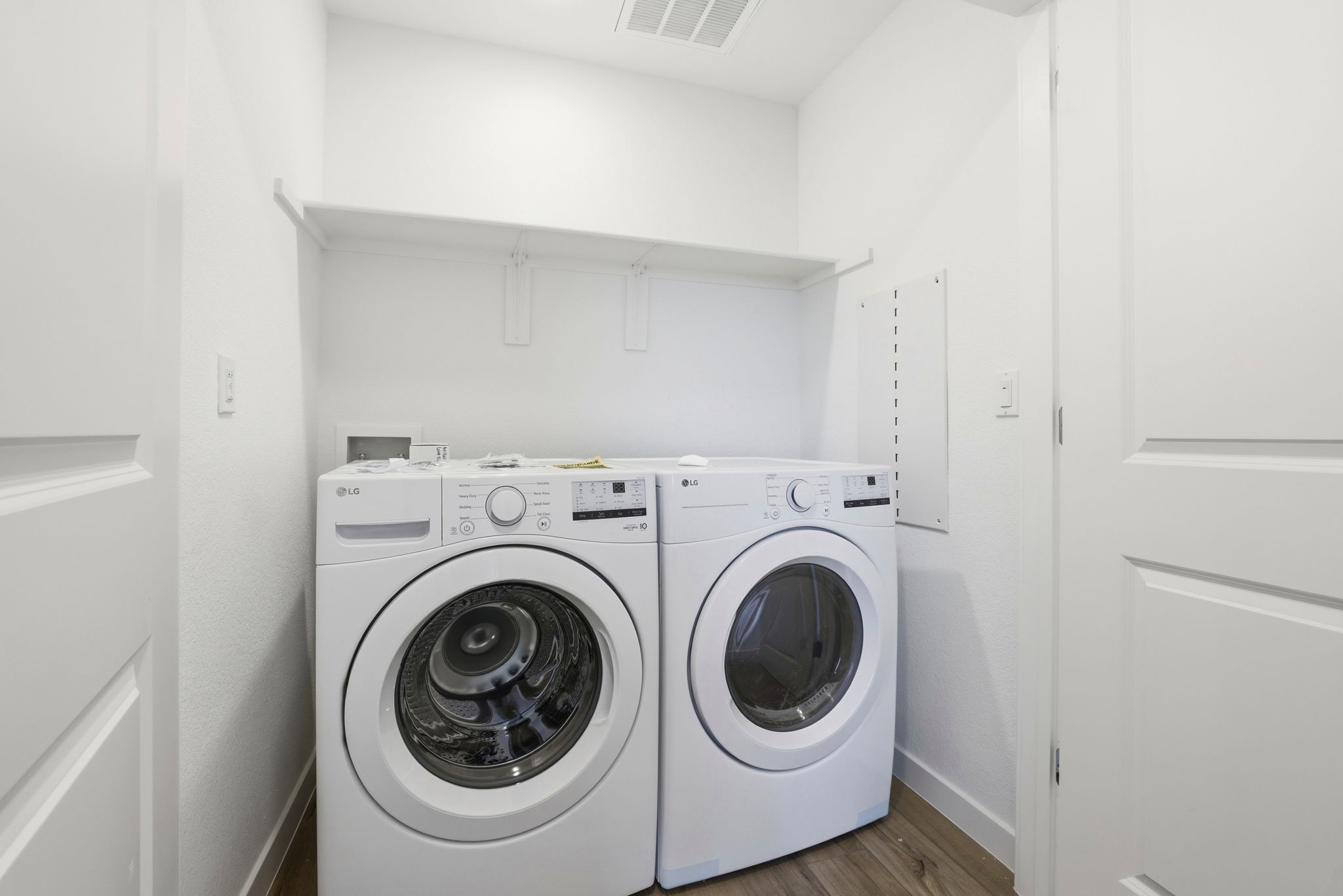A washing machine and dryer in a room.