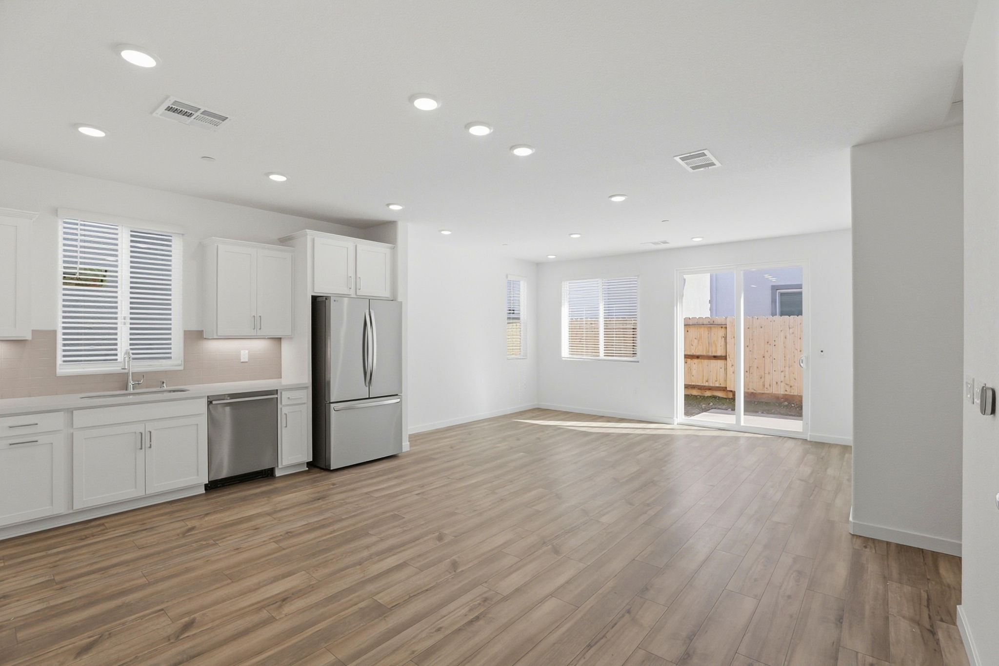 A kitchen with white cabinets.