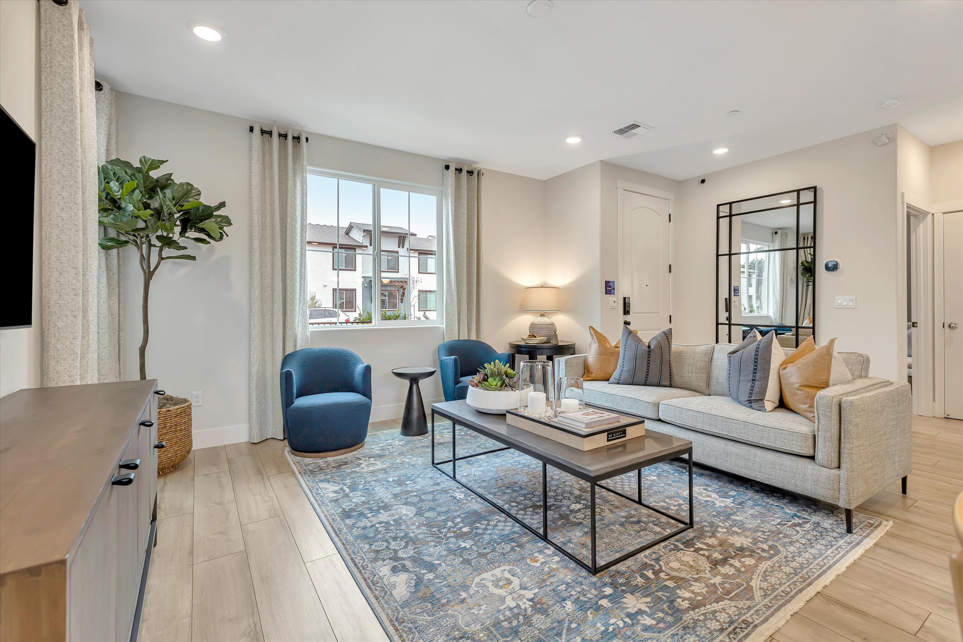 A living room with a large rug.