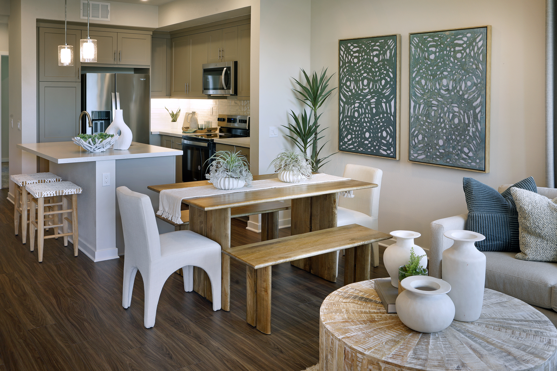 A living room with a table and chairs.