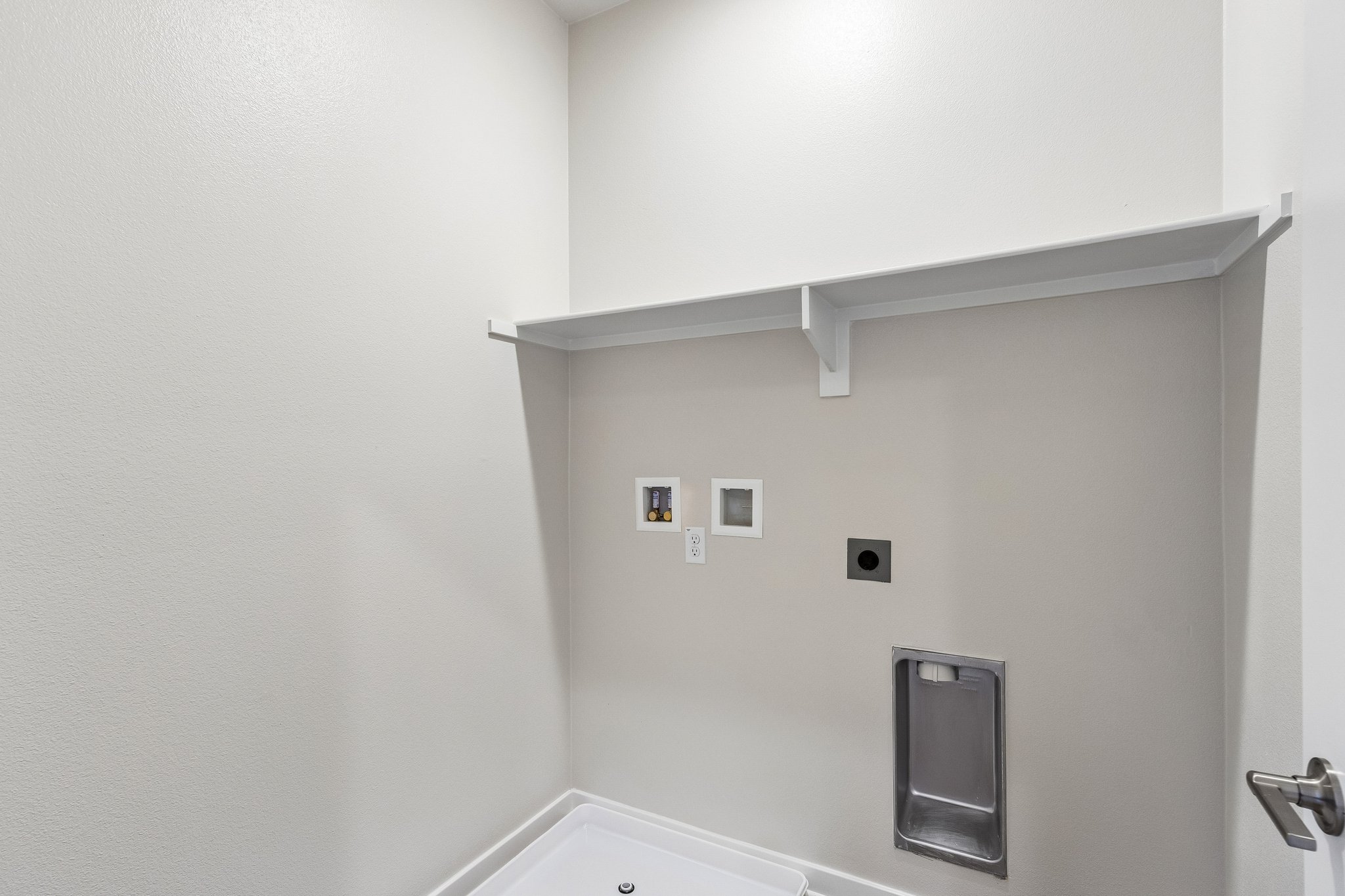A bathroom with a shelf and a mirror.