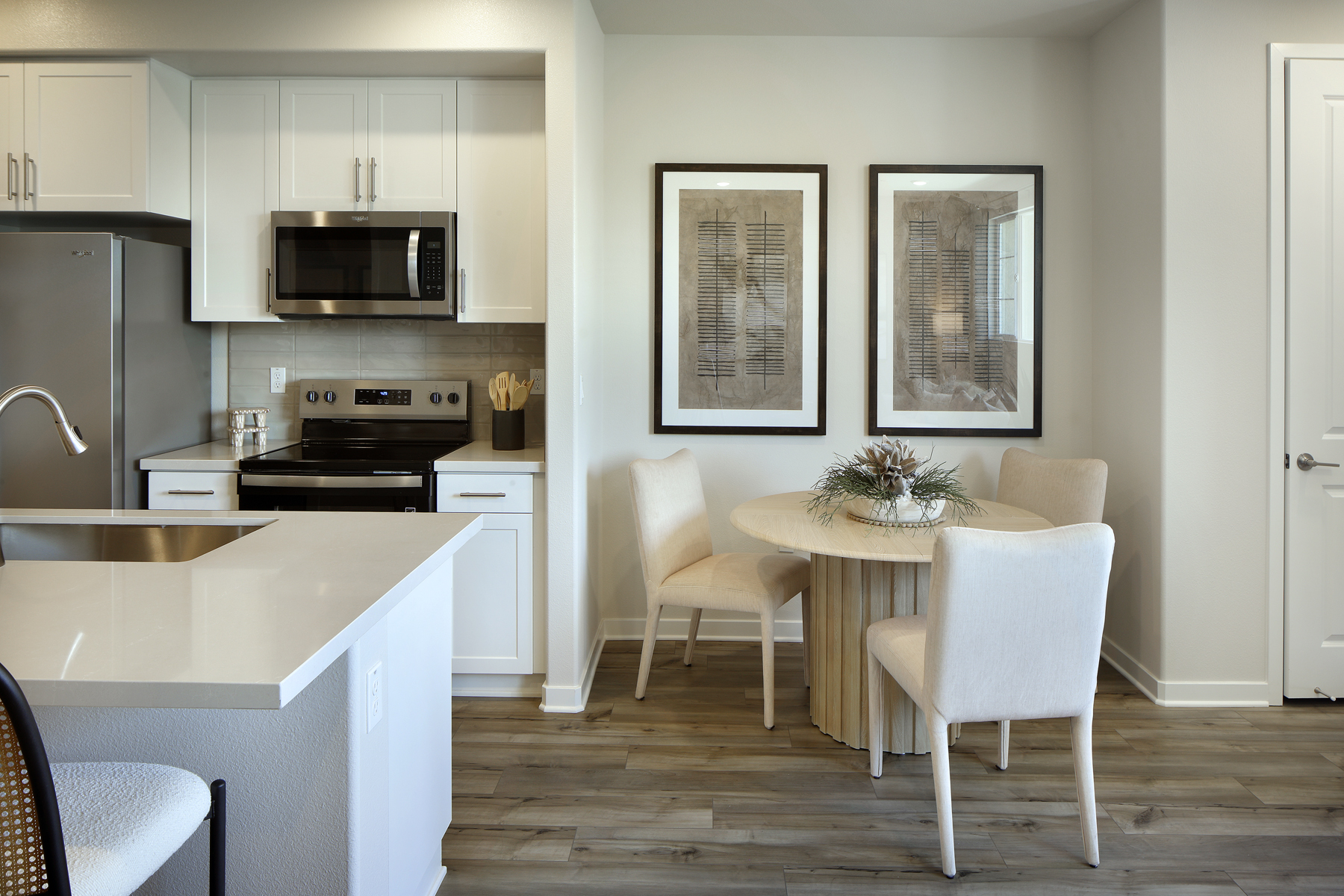 A kitchen with white cabinets.