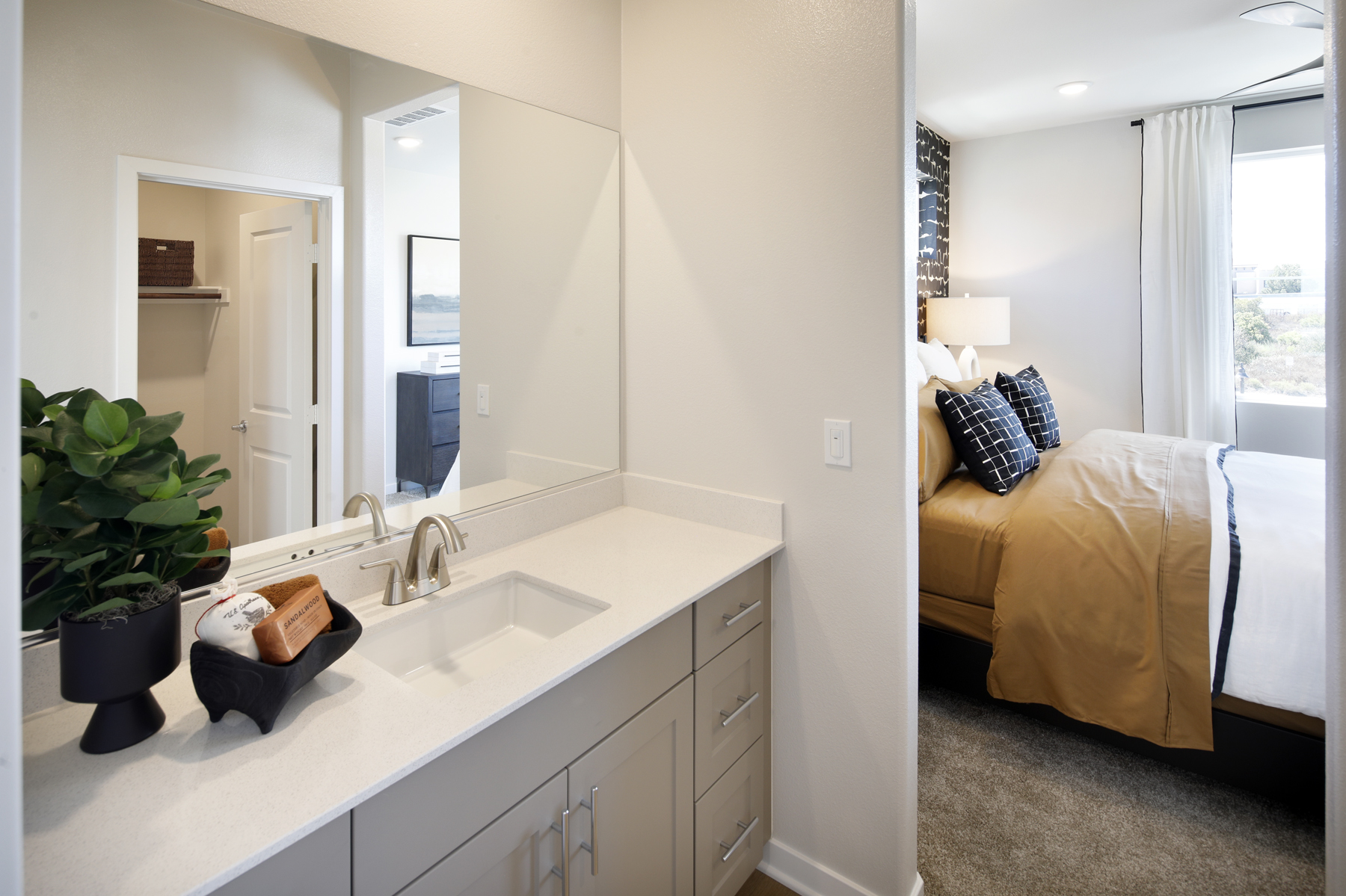A bathroom with a bed and a sink.