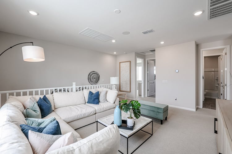 A living room with white couches.