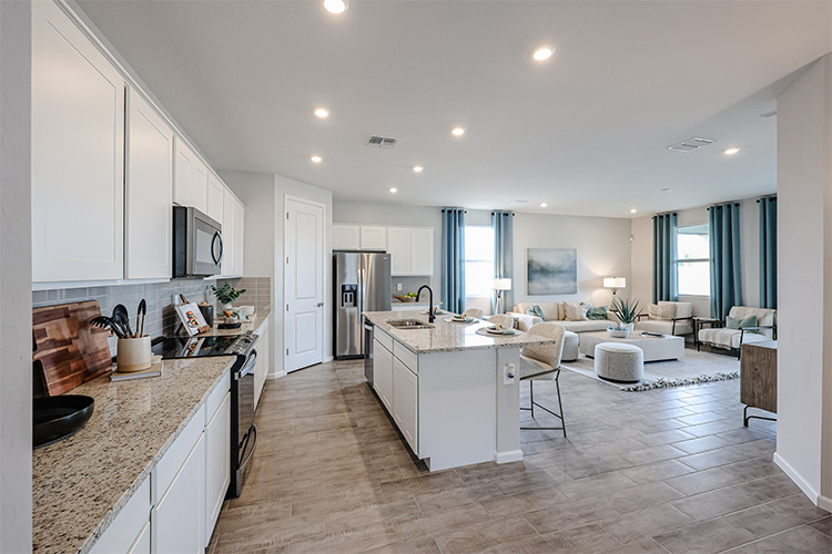 A kitchen with white cabinets.
