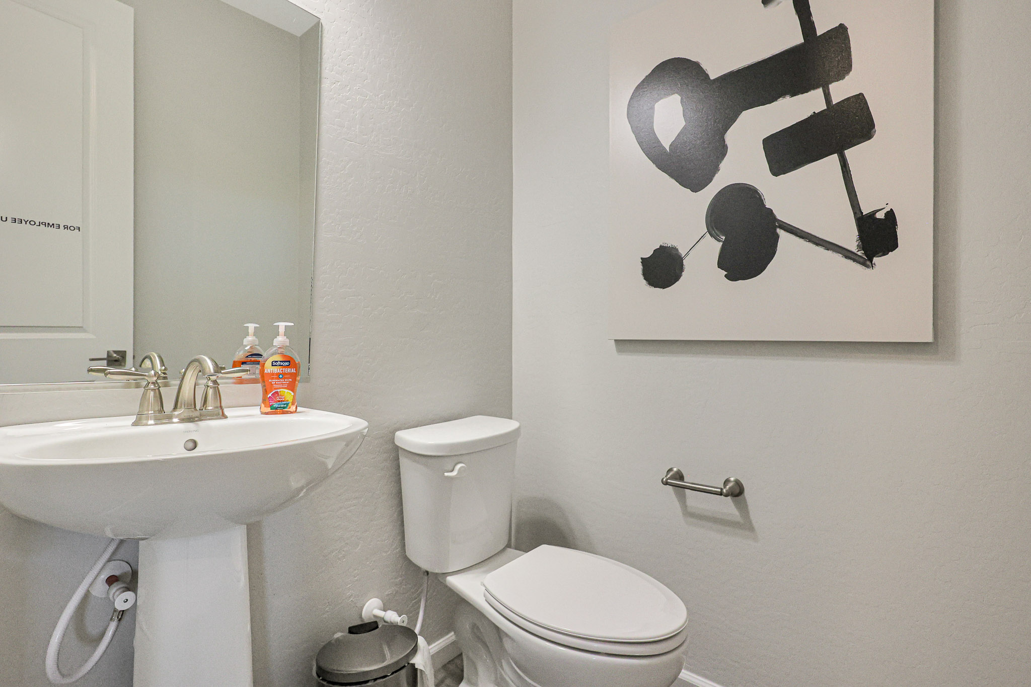 A bathroom with a toilet and sink.