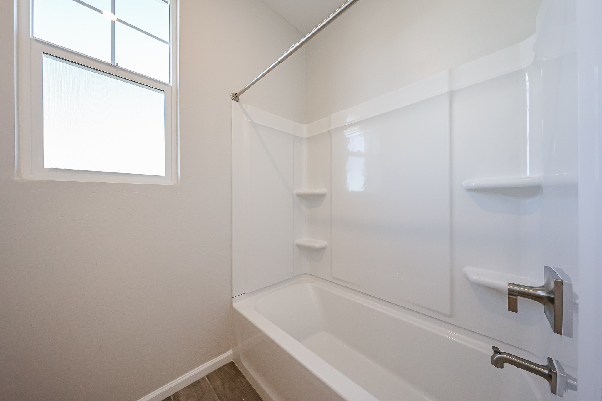 A bathtub and a window.