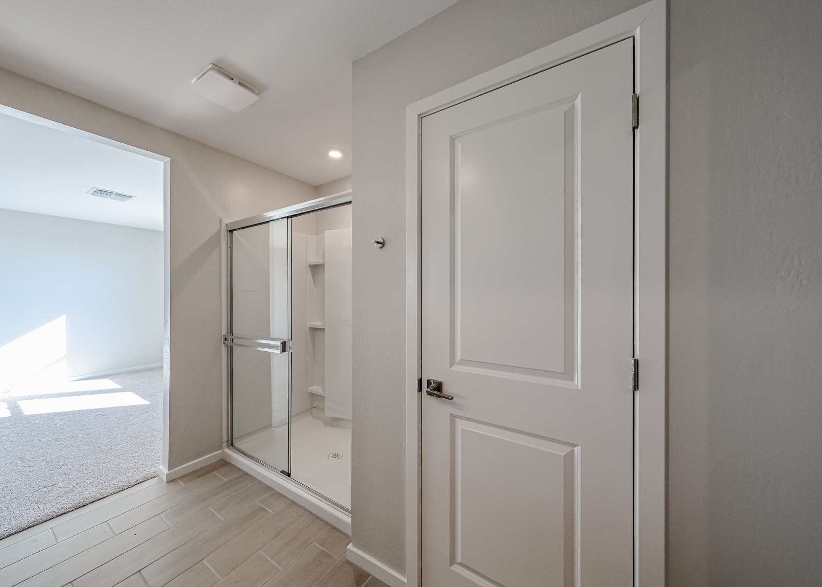 A bathroom with a glass door.