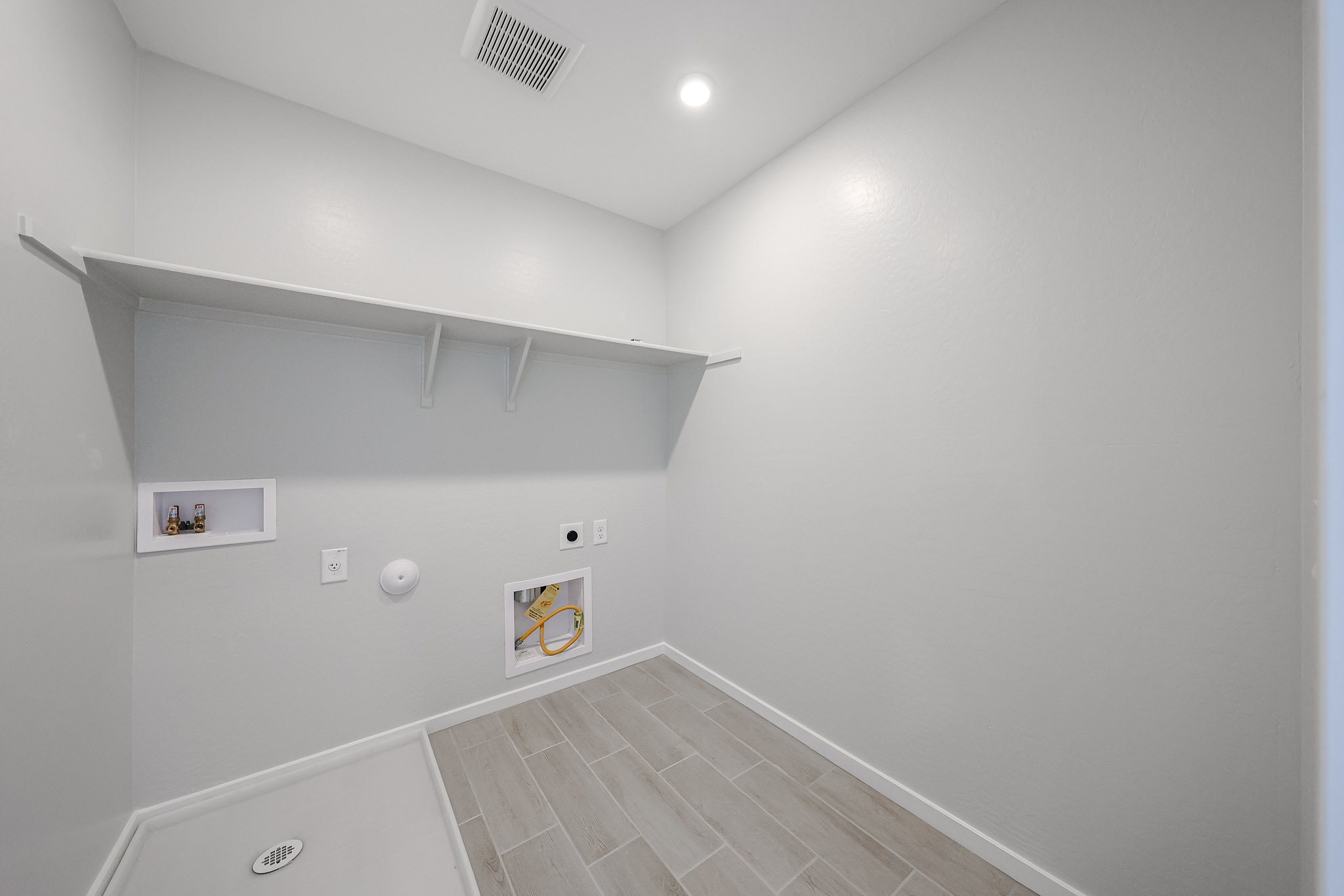 A white tiled hallway.