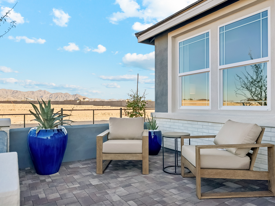 A patio with chairs and a table.