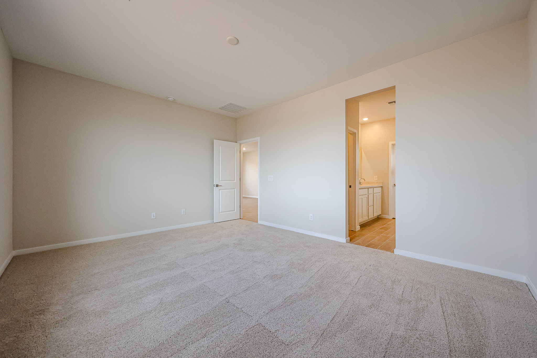 A hallway with white walls.