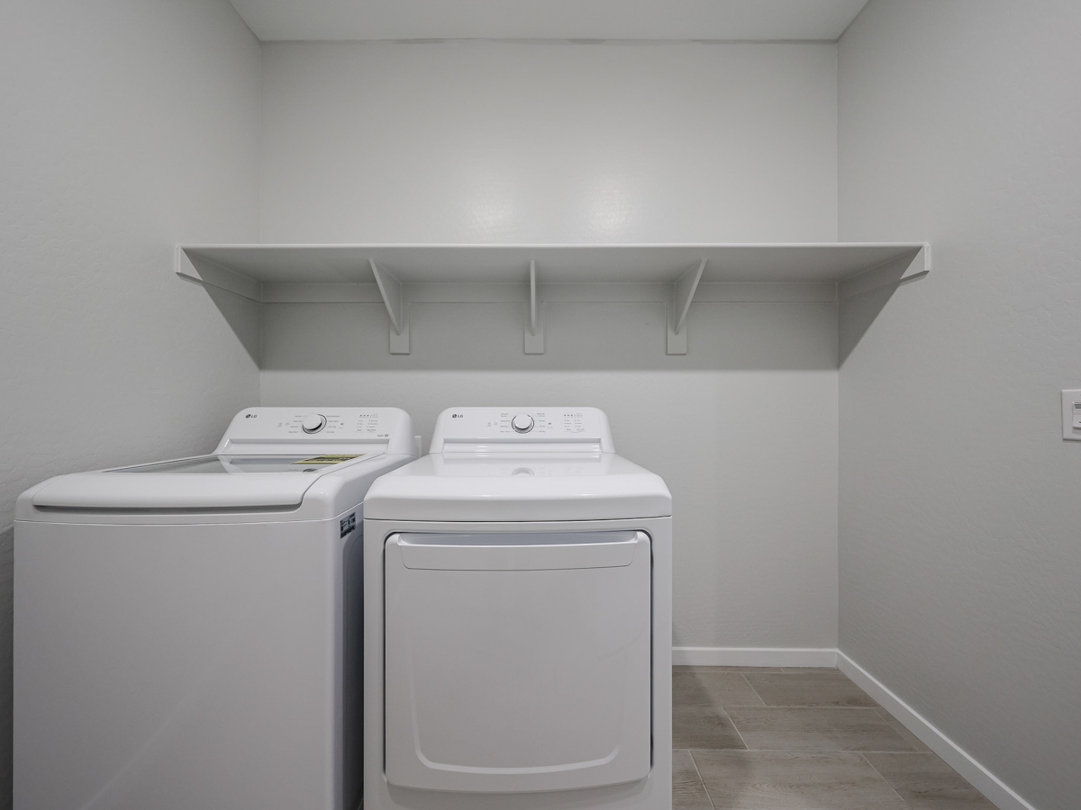 A washing machine and dryer in a room.