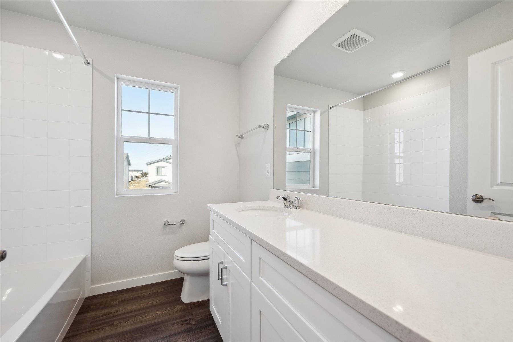 A bathroom with a tub toilet and sink.