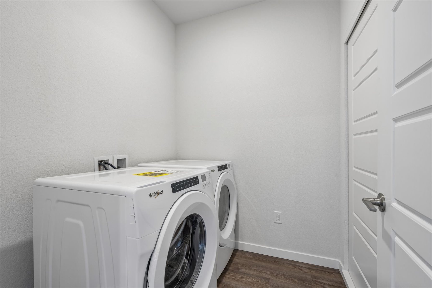 A white washing machine in a room.