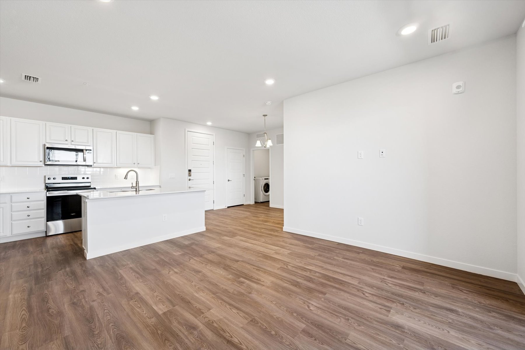 A kitchen with white cabinets.