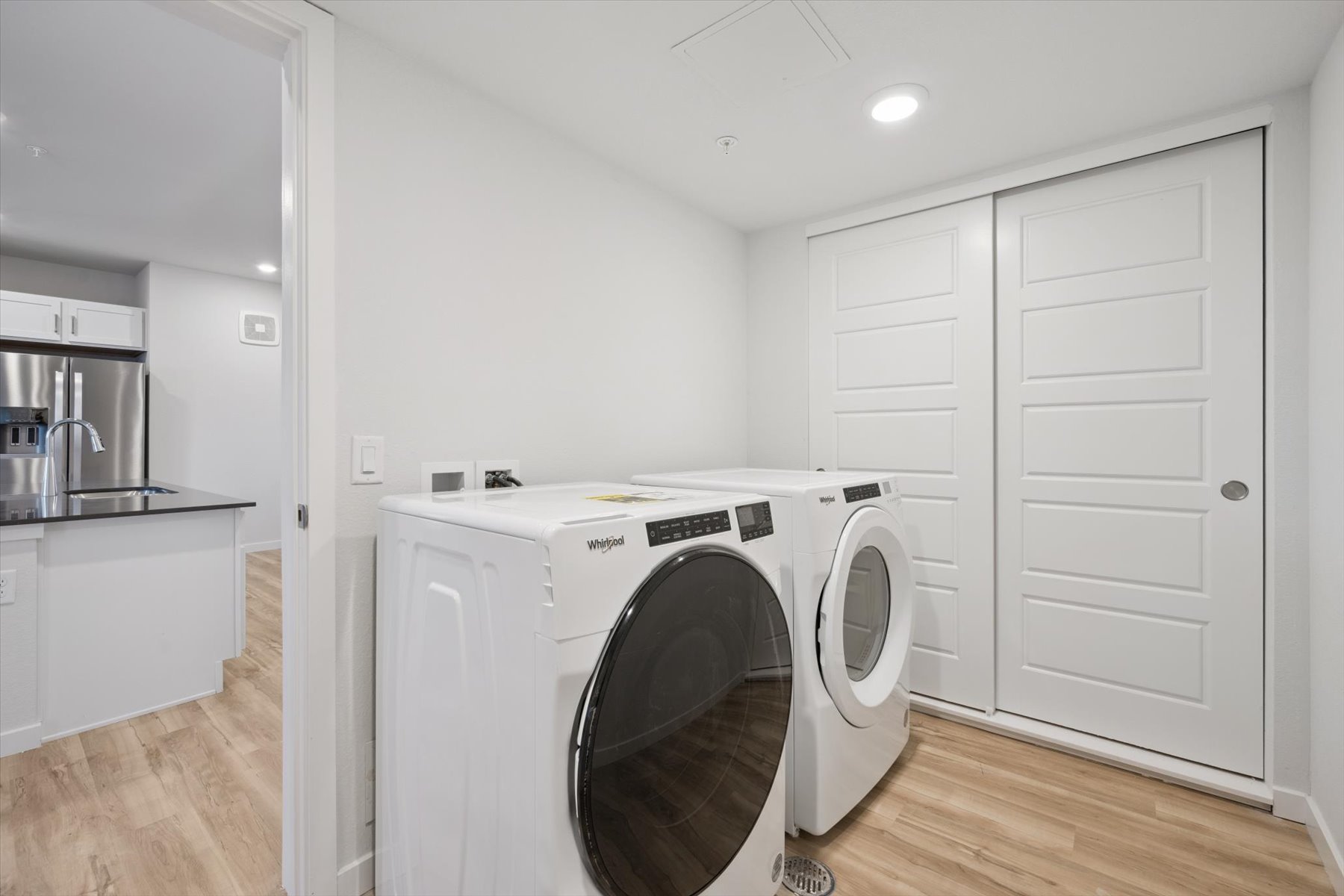 A white laundry room with a washer and dryer.
