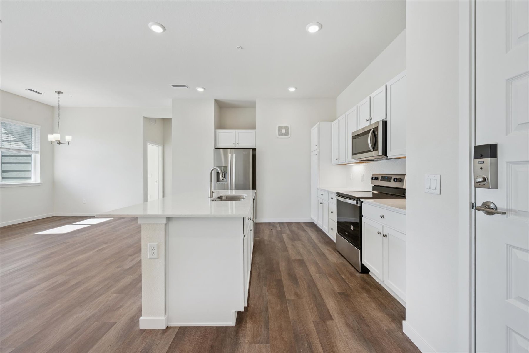 A kitchen with white cabinets.