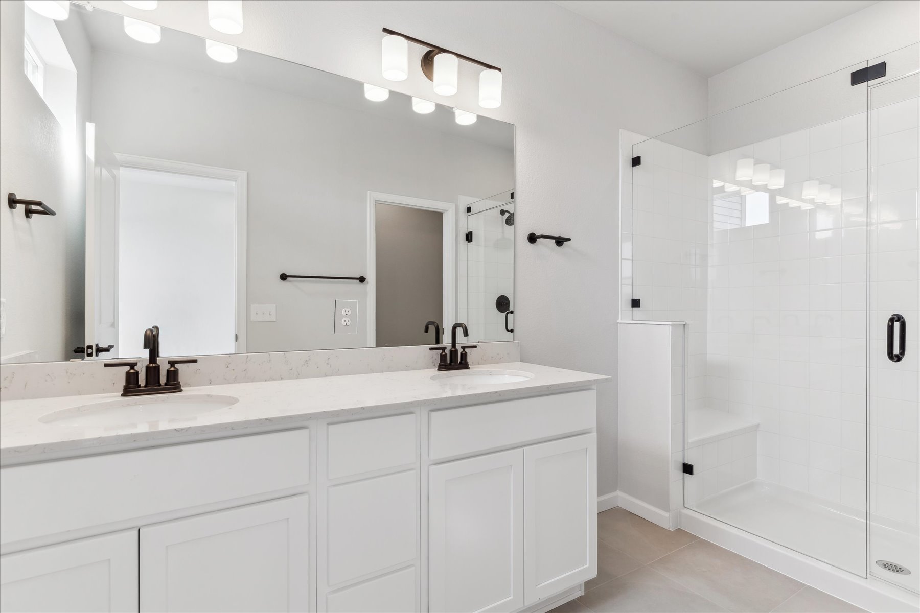 A bathroom with a large mirror.