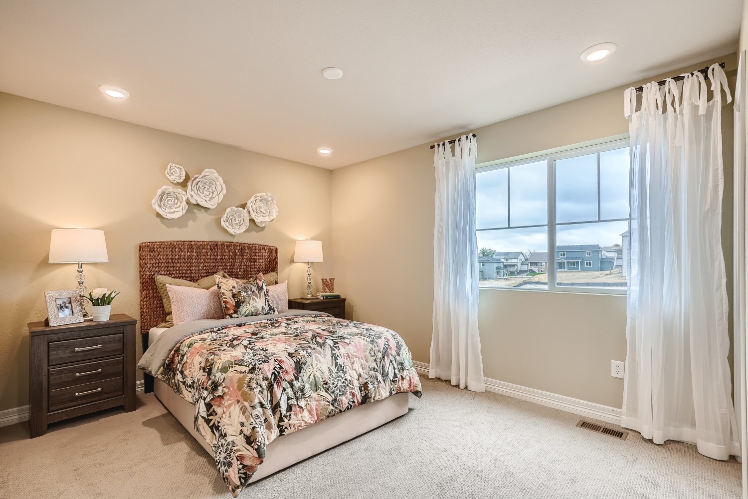 A bedroom with a large window.