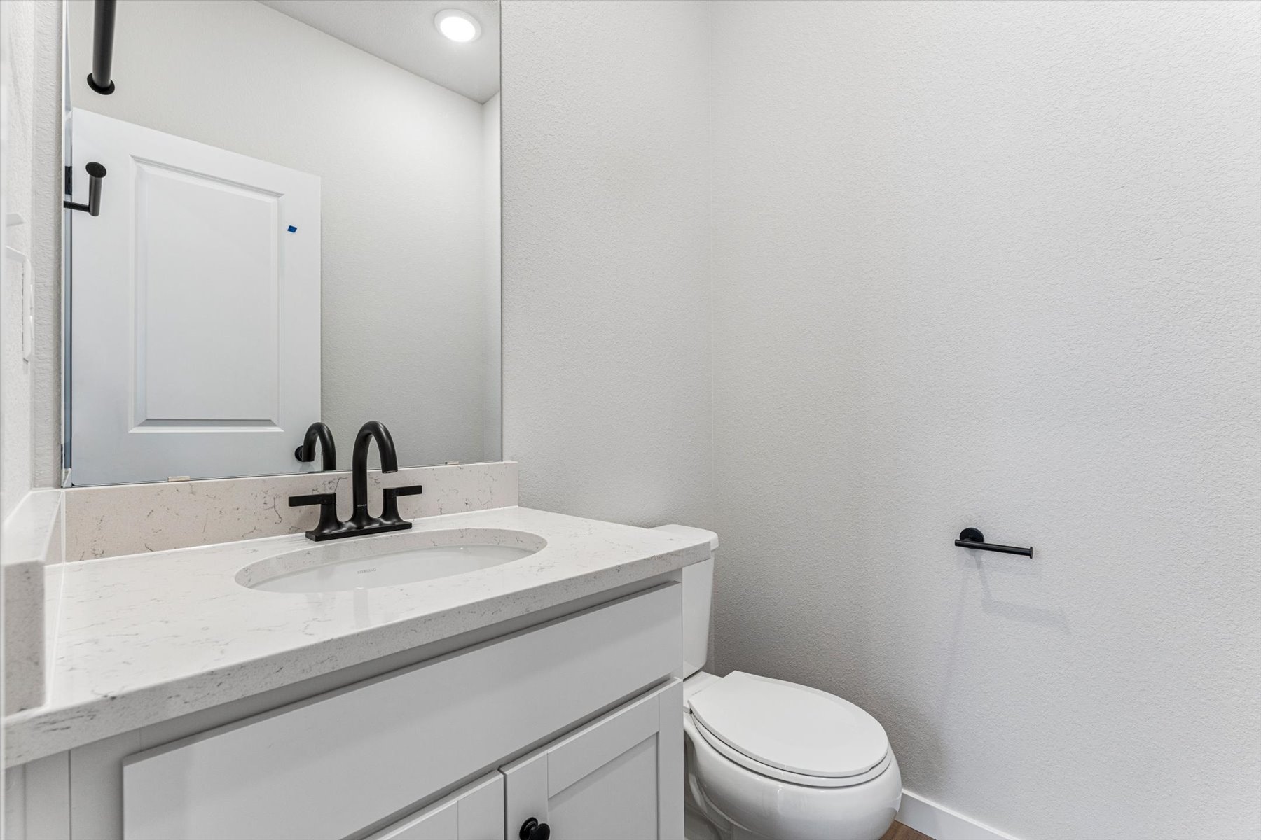 A bathroom with a sink and toilet.