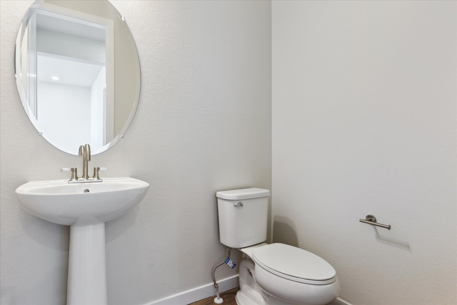 A bathroom with a toilet and sink.