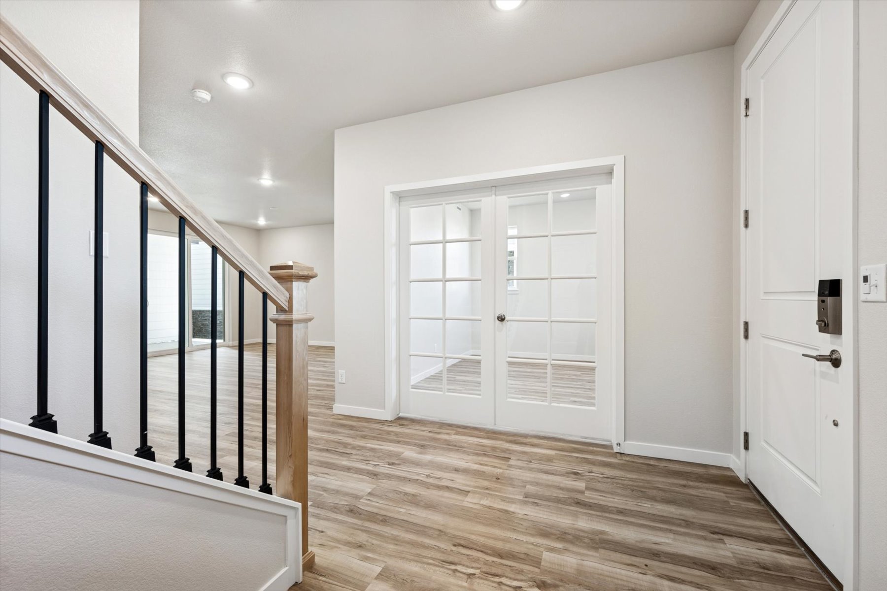 A room with white walls and a wood floor.