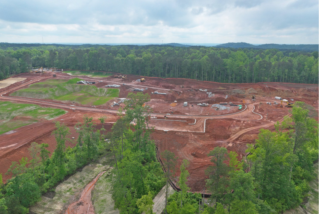 A landscape with trees and a road.