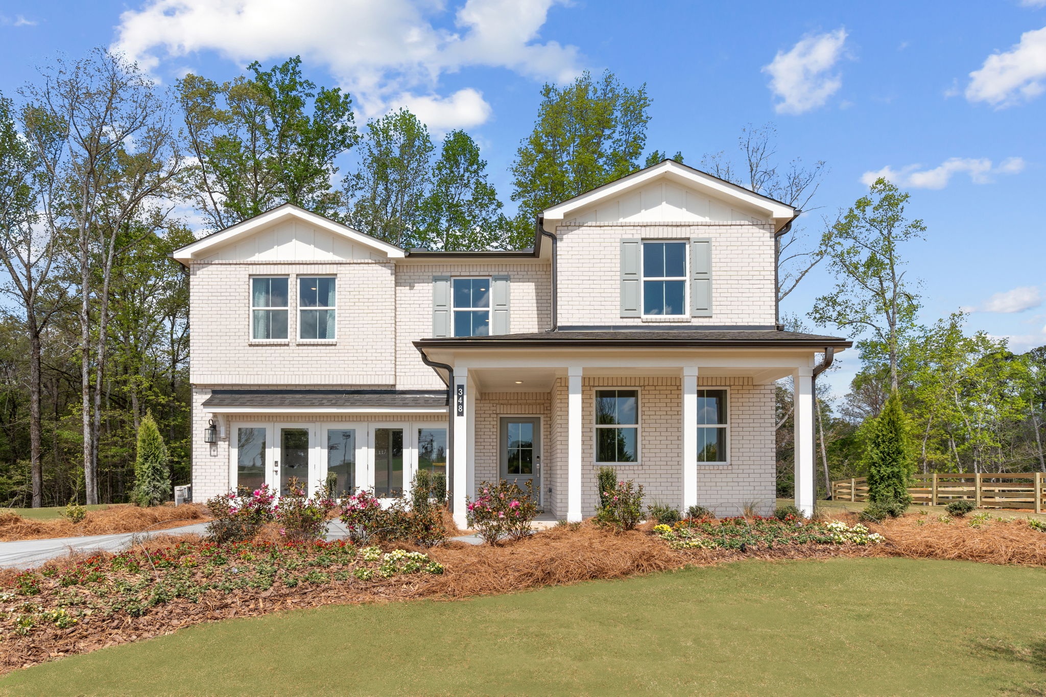 A large house with a large front yard.
