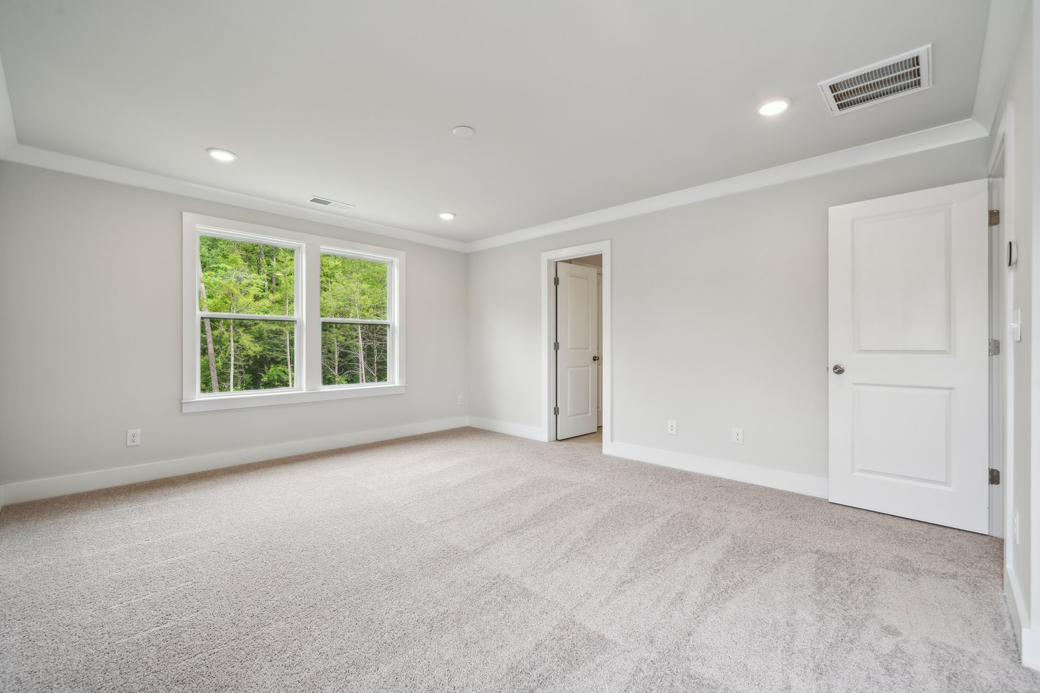 A room with white walls and a window.