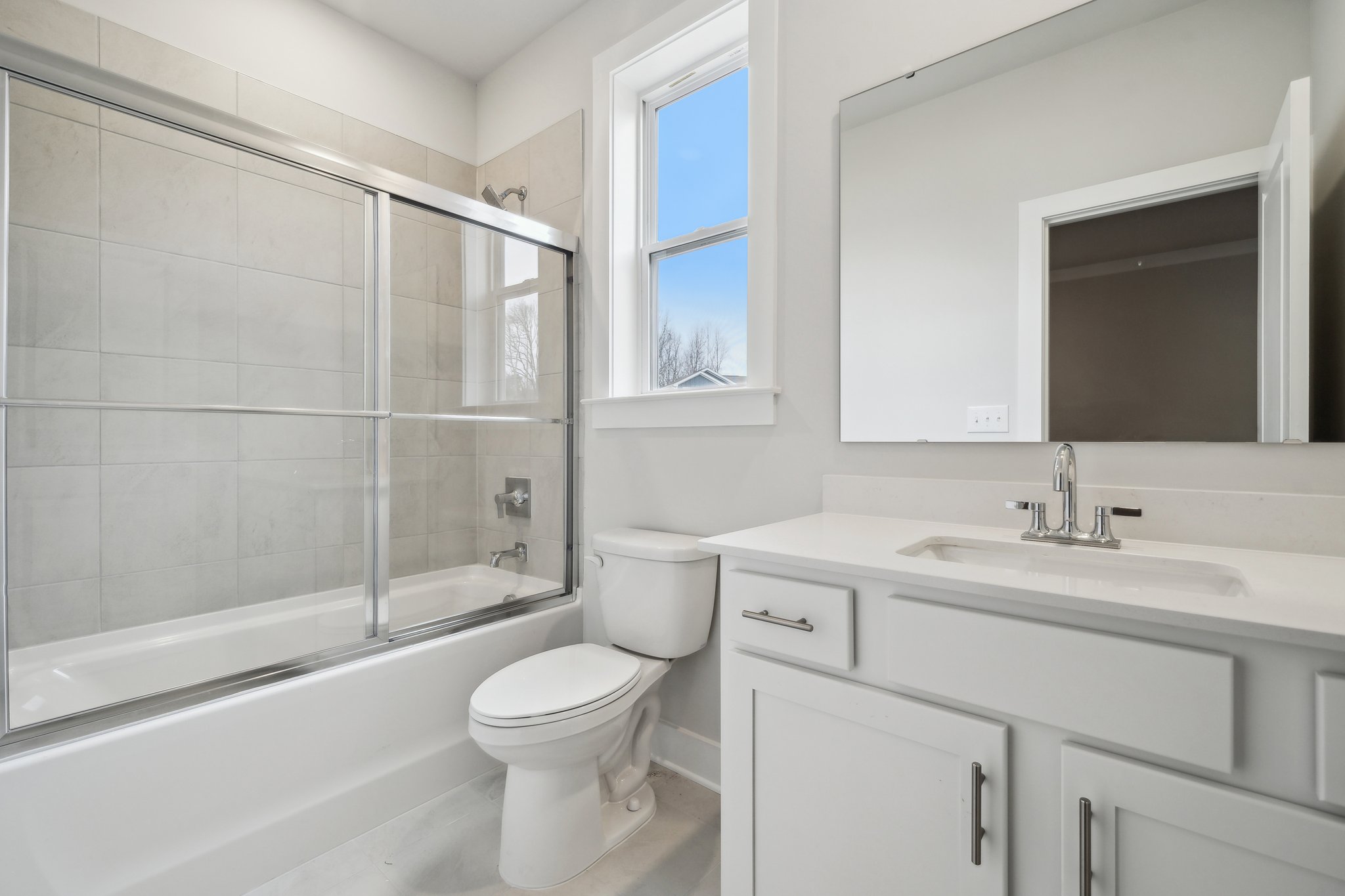 A bathroom with a tub toilet and sink.