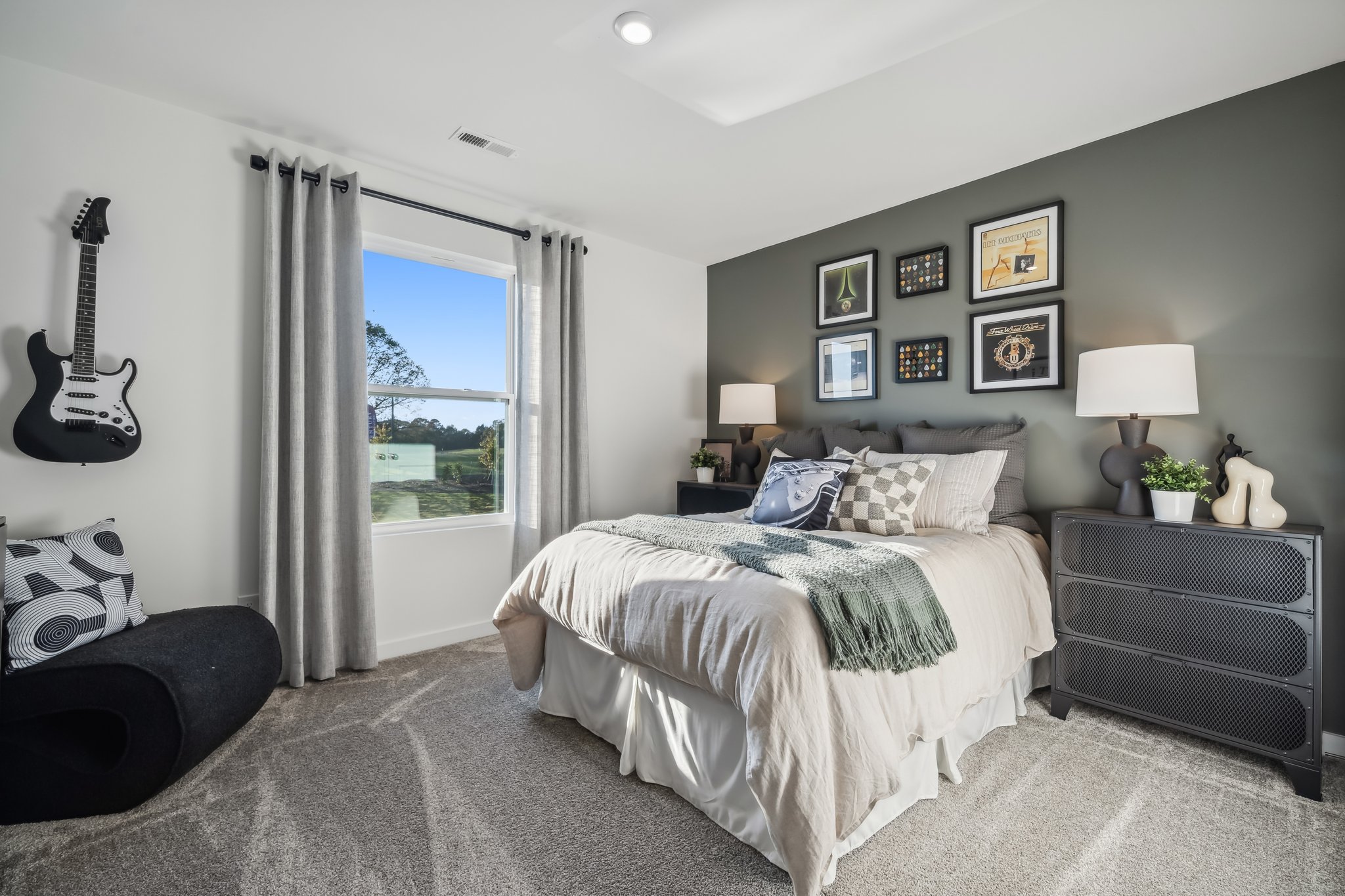 A bedroom with a large window.