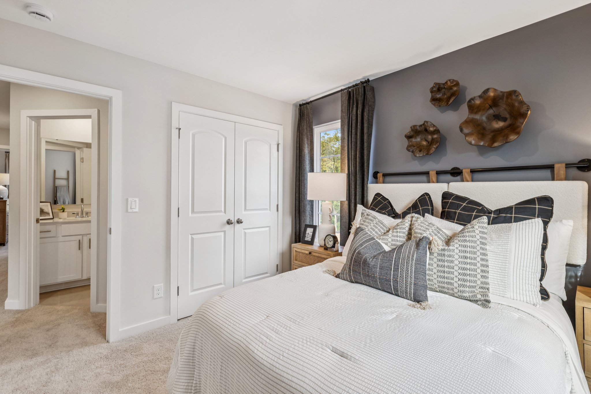 A bedroom with a bed and a lamp.