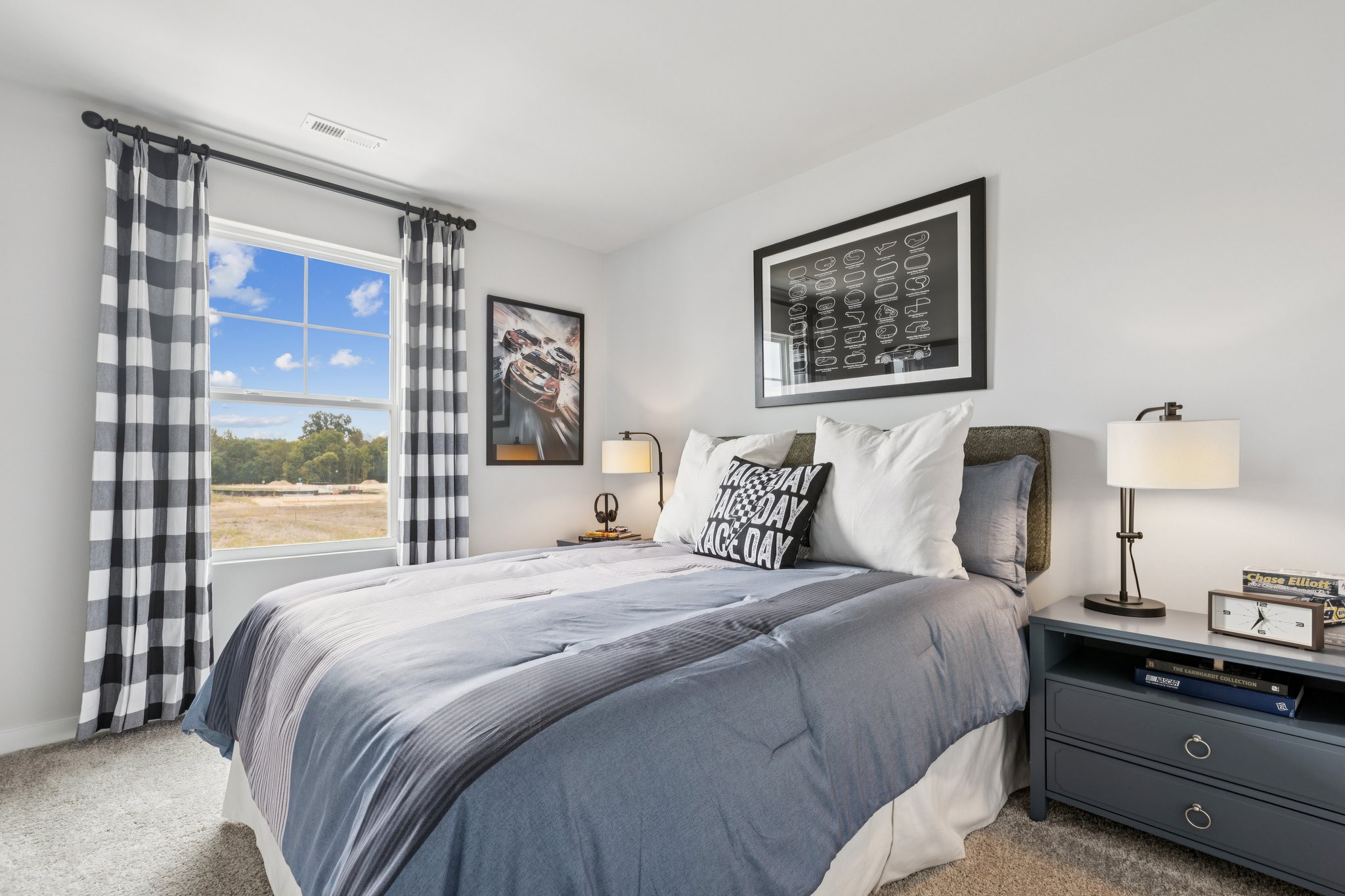 A bedroom with a large window.