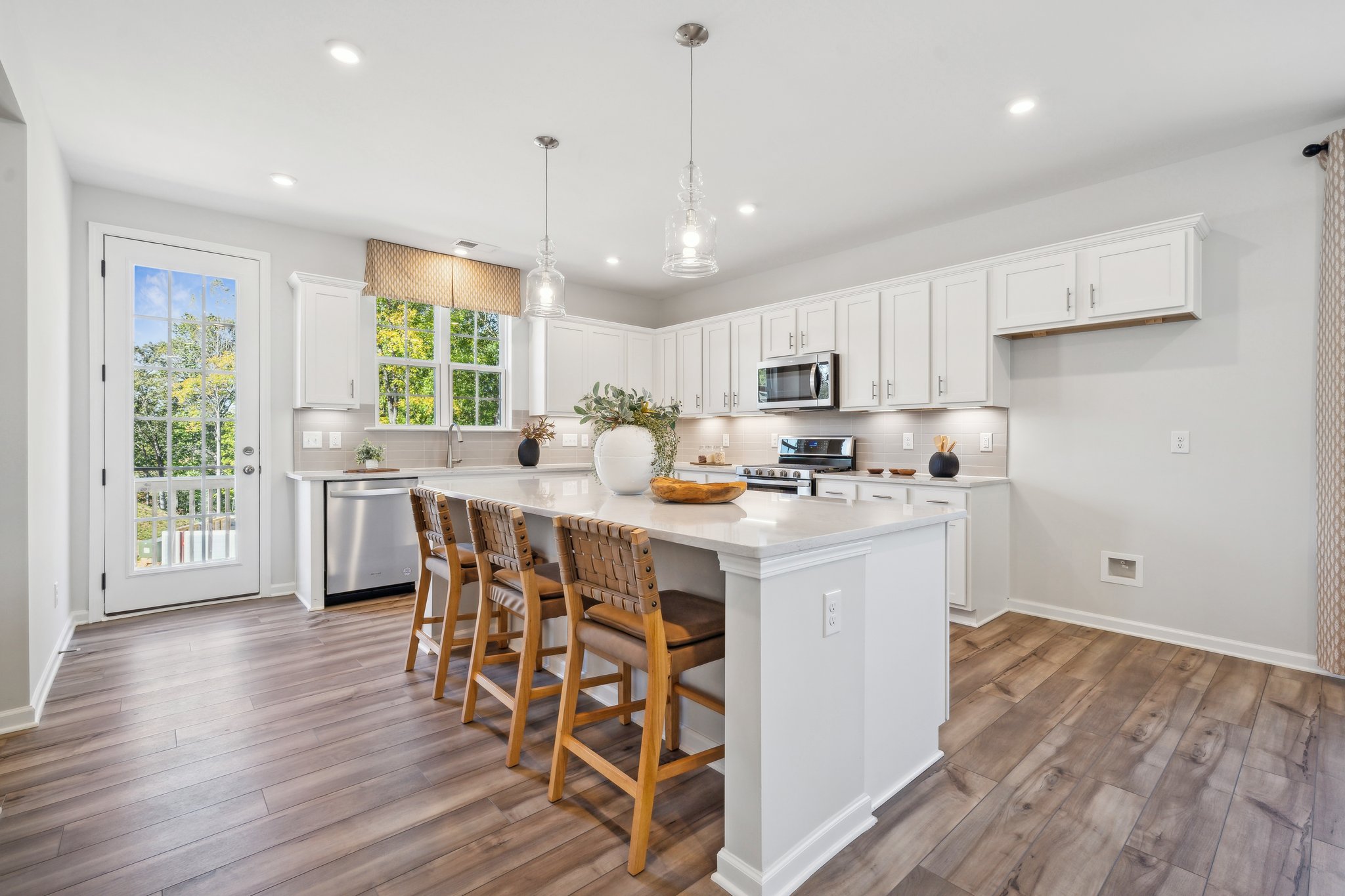 A kitchen with white cabinets.