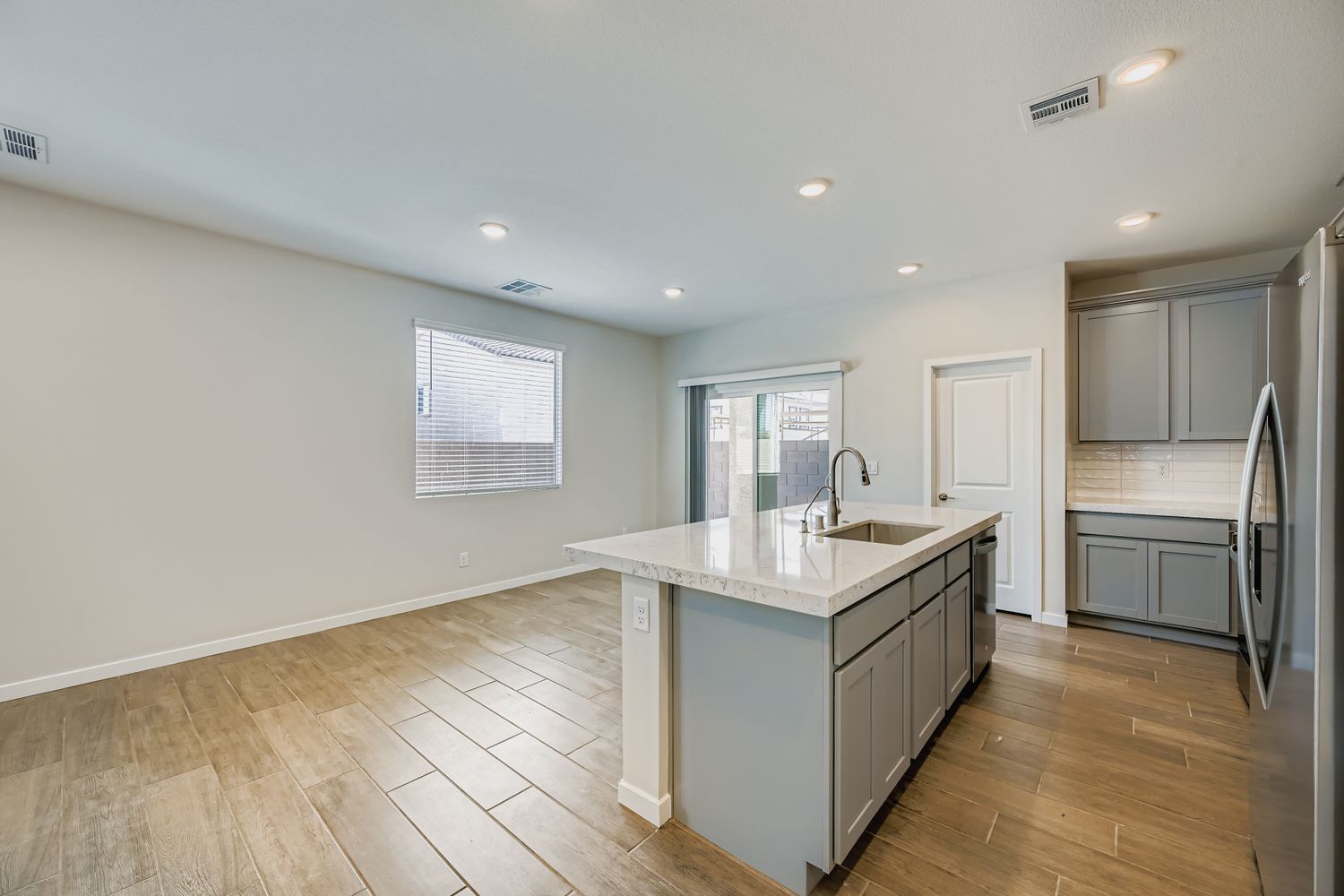 A kitchen with white cabinets.