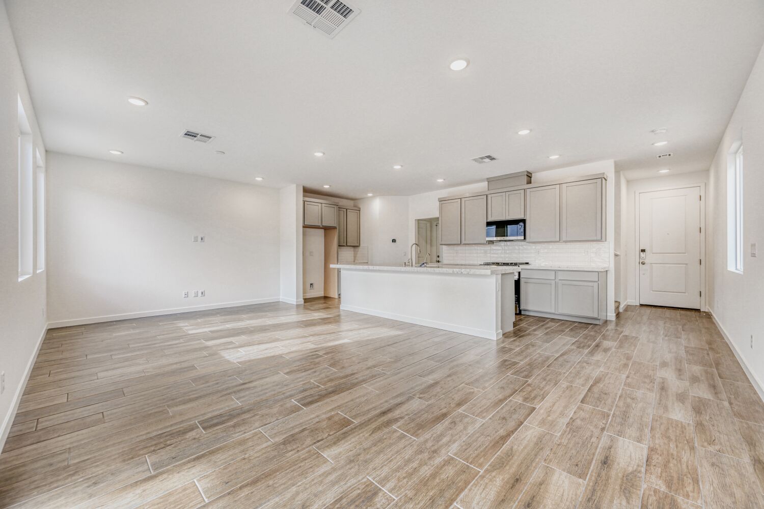 A large kitchen with white cabinets.