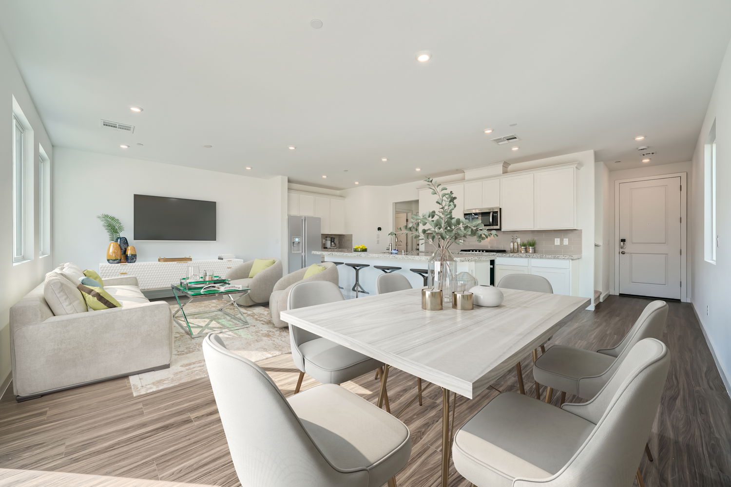A large living room with a large table and chairs.