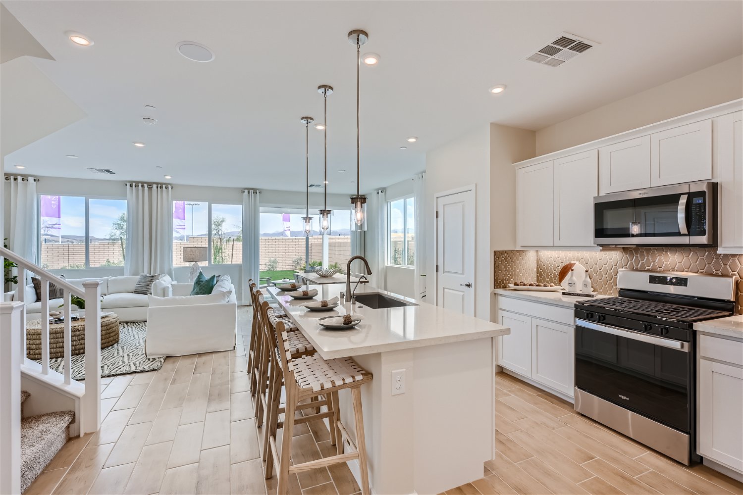 A kitchen with a dining table and chairs.