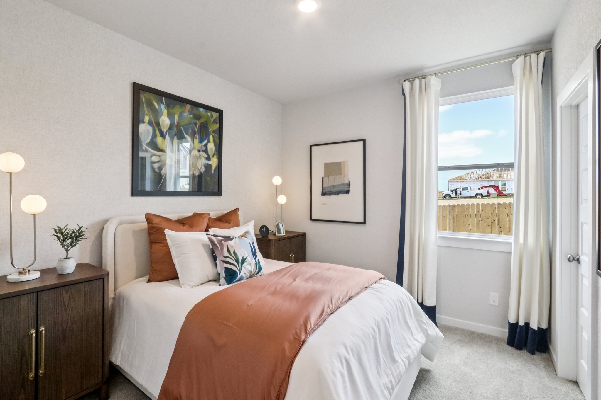 A bedroom with a large window.