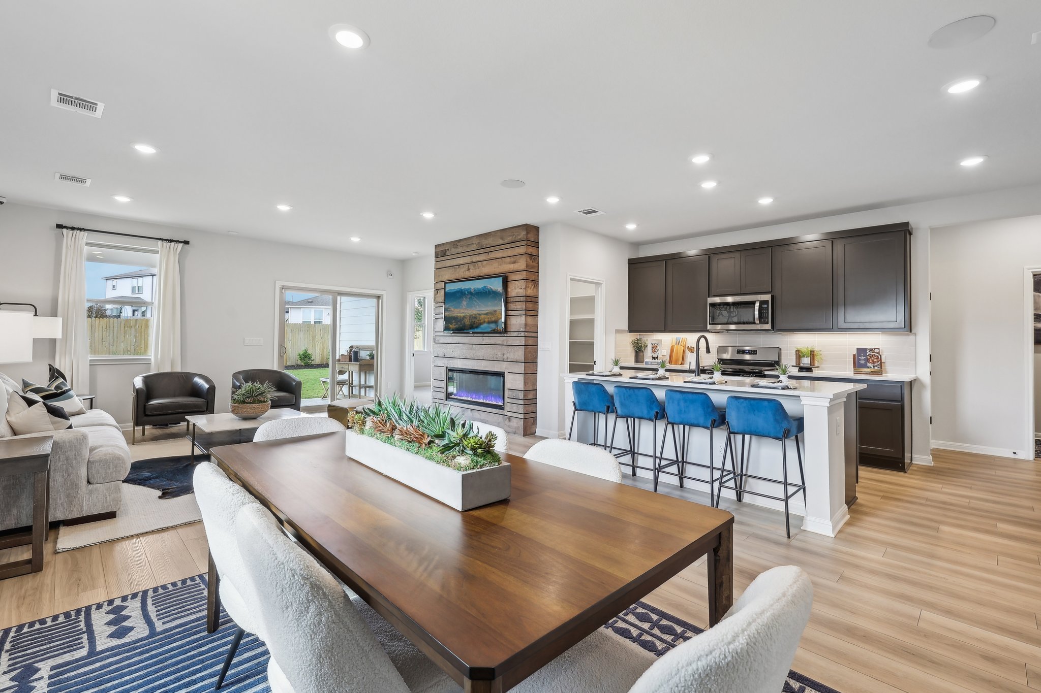 A large kitchen with a dining table.