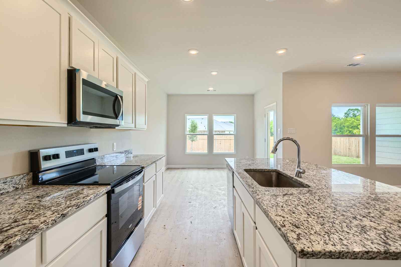 A kitchen with marble counters.