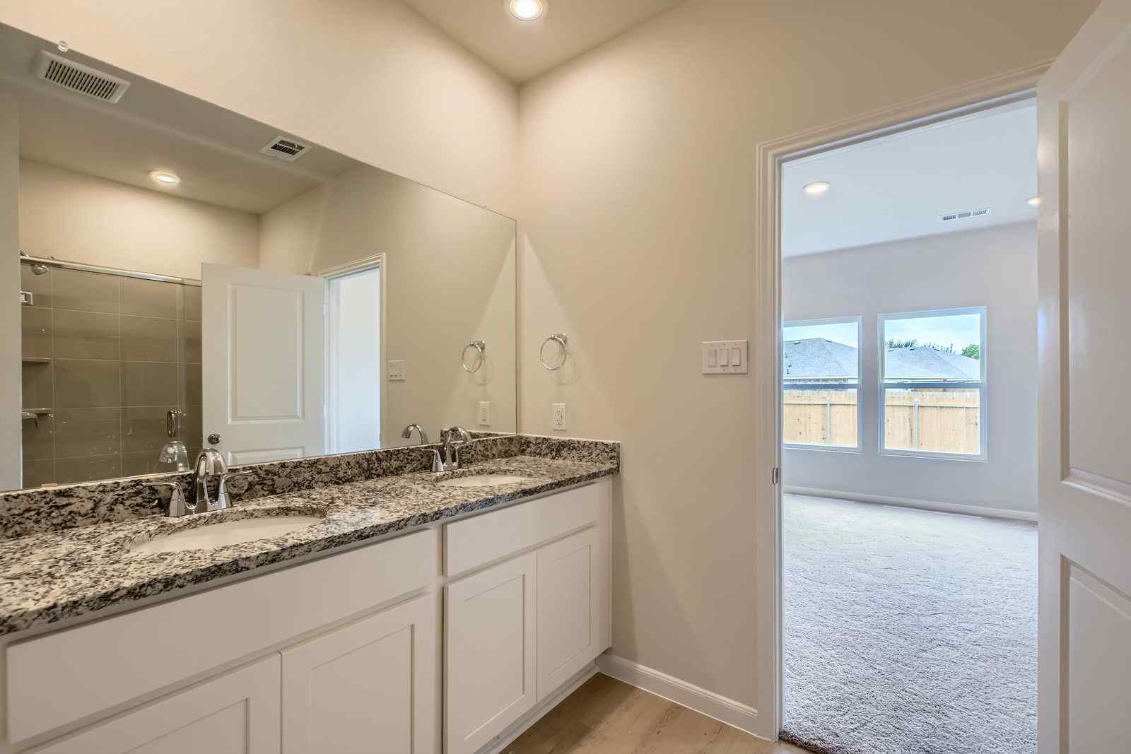 A bathroom with a marble countertop.