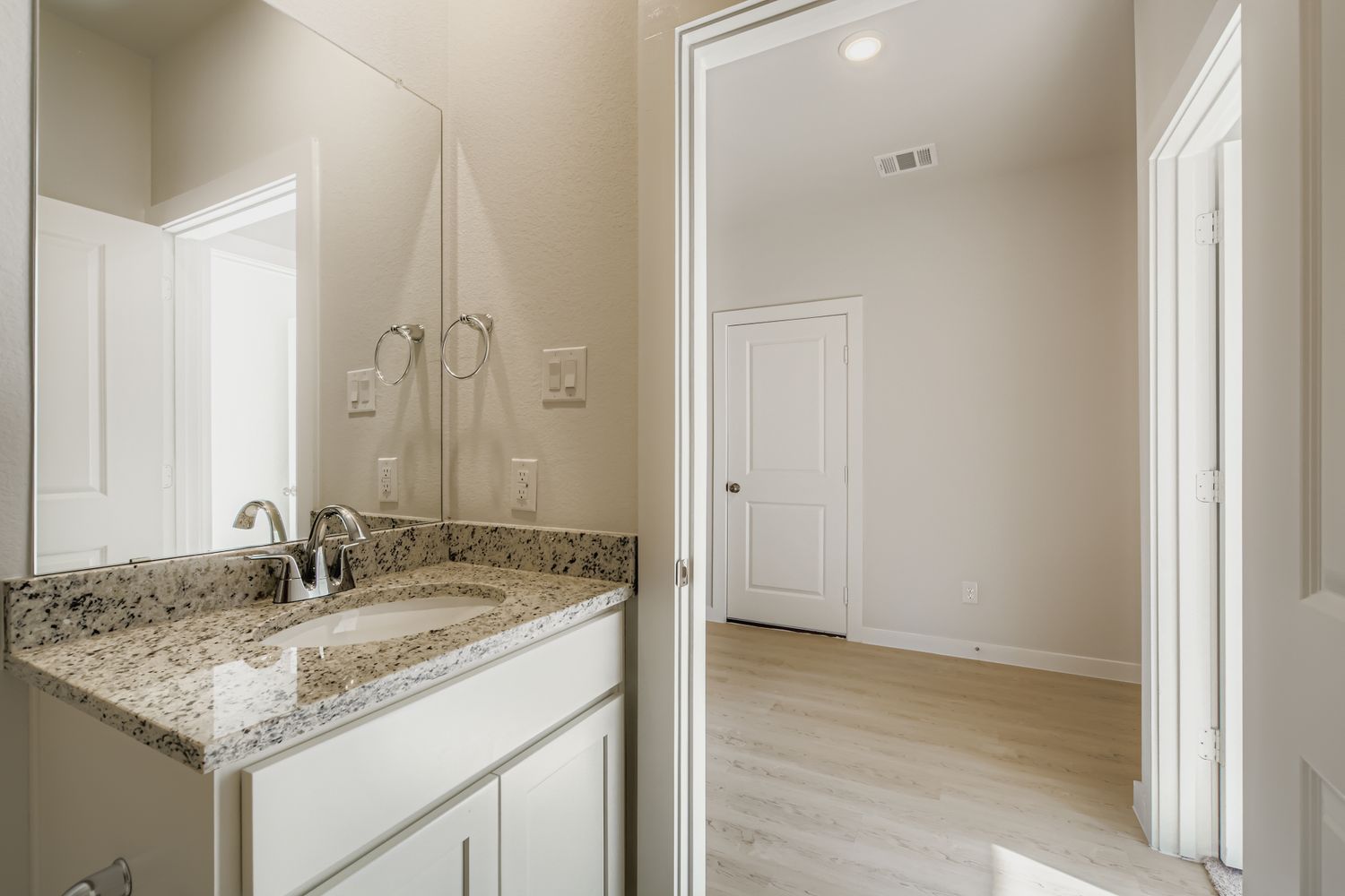 A bathroom with a marble countertop.