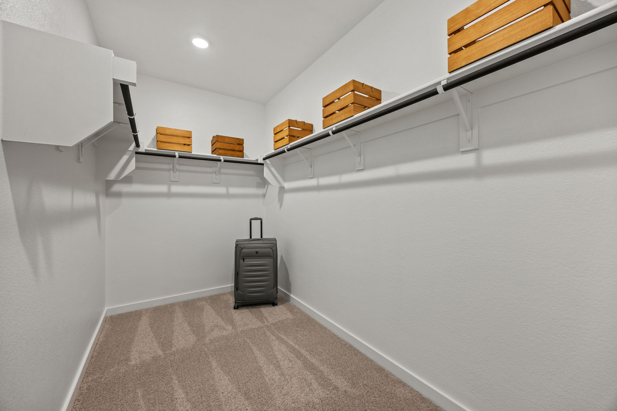 A room with shelves and a suitcase.