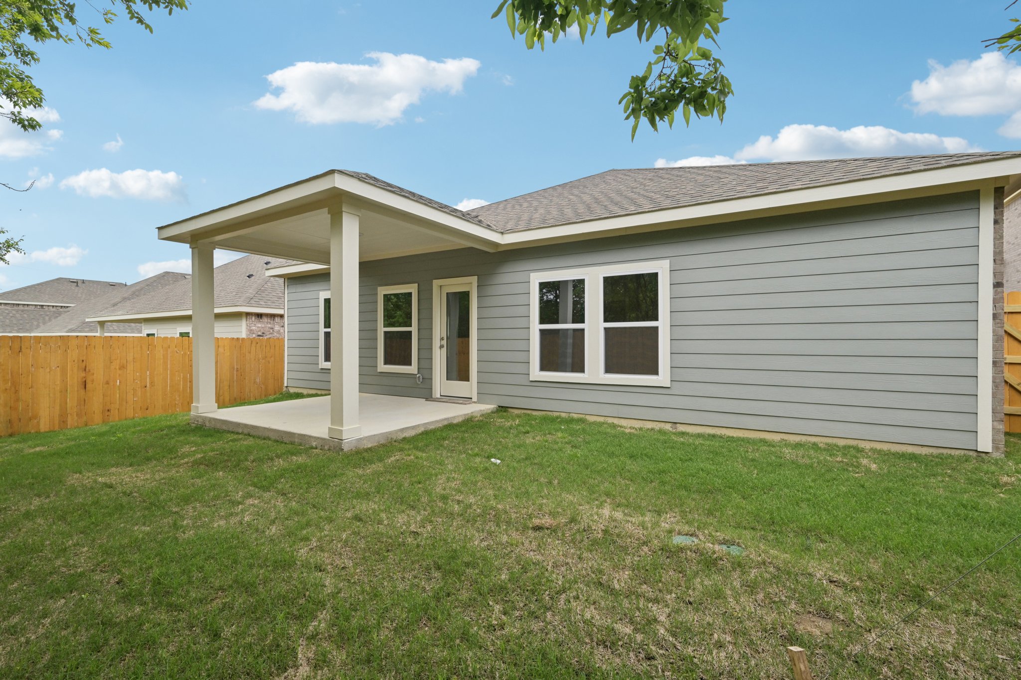 A house with a fence and grass.