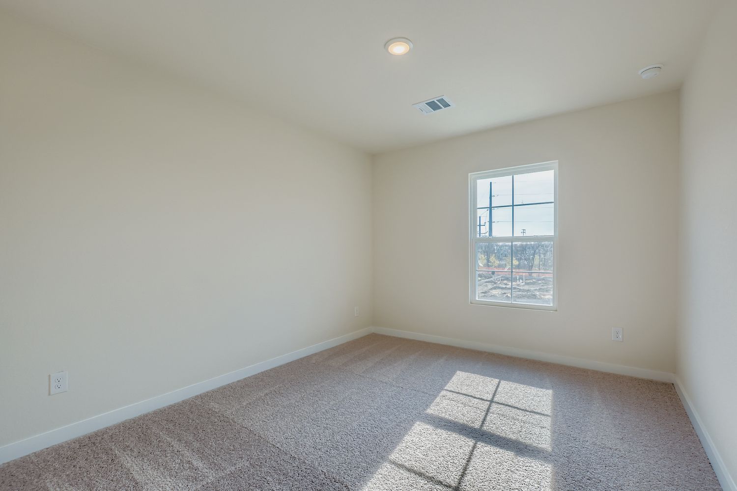 A room with a window and a tile floor.