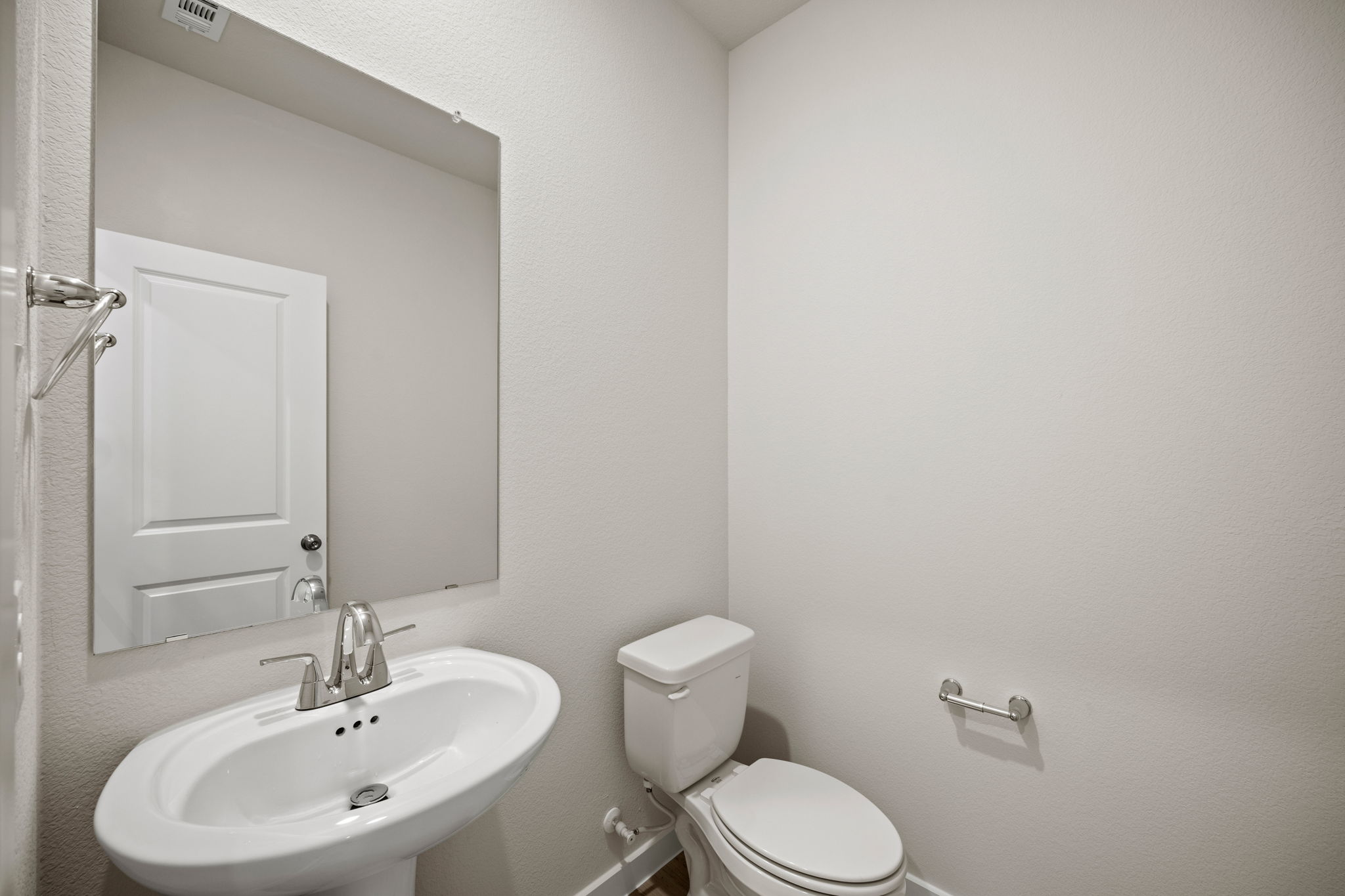 A bathroom with a toilet and sink.