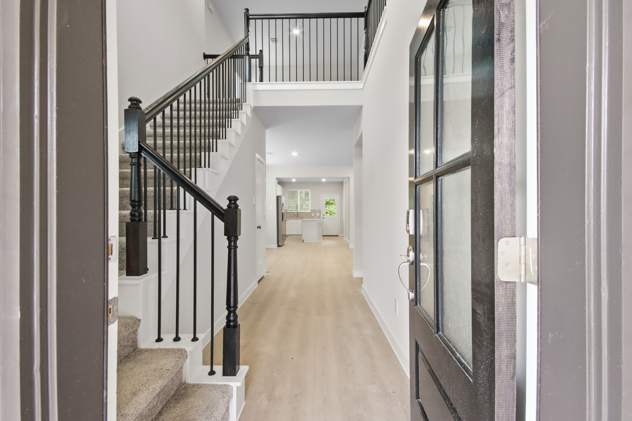 A hallway with black railings.